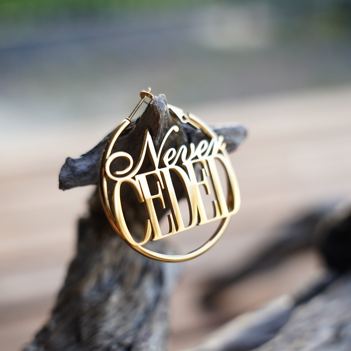 NEVER CEDED HOOP EARRINGS